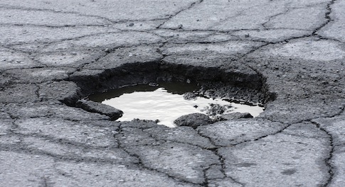 Government pledges £6billion to rid the UK of potholes